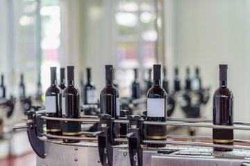 In the final stage, the finished wine is bottled, labelled, and prepared for release.