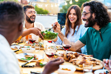Group of friends enjoying a meal together outdoors.