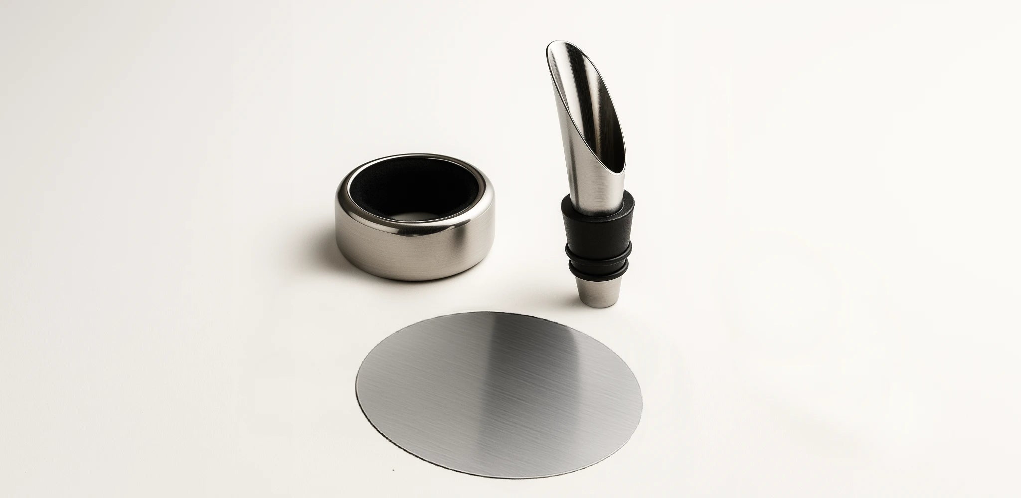 Pouring accessories refine wine service: the spout improves flow, the anti-drip ring protects the bottle and table, and the thin disc drop stopper prevents drips for an elegant, precise presentation.