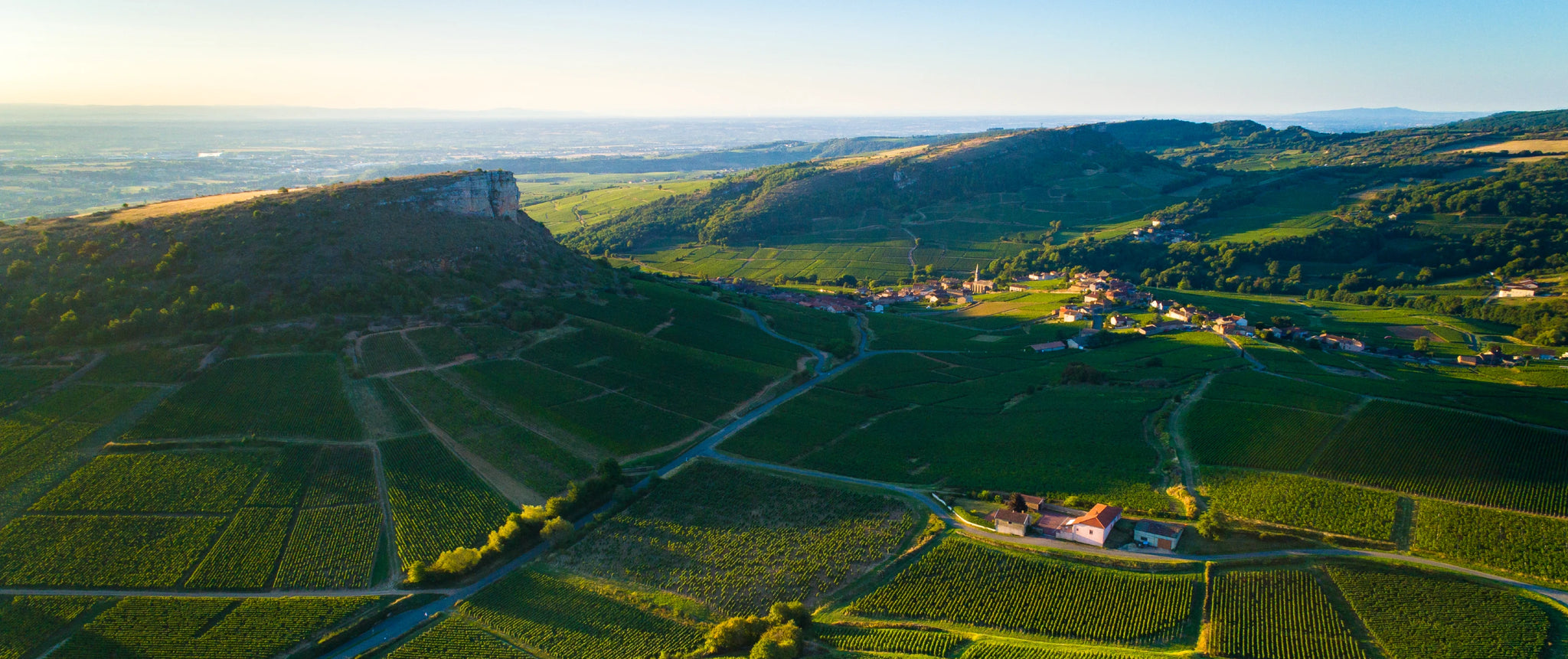 Aerial view of the Rock of Vergisson and surrounding vineyards in the Mâconnais region, home to newly protected Bourgogne appellations like Pouilly-Fuissé. Source: BIVB / Aurélien IBANEZ