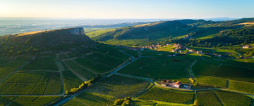 Aerial view of the Rock of Vergisson and surrounding vineyards in the Mâconnais region, home to newly protected Bourgogne appellations like Pouilly-Fuissé. Source: BIVB / Aurélien IBANEZ